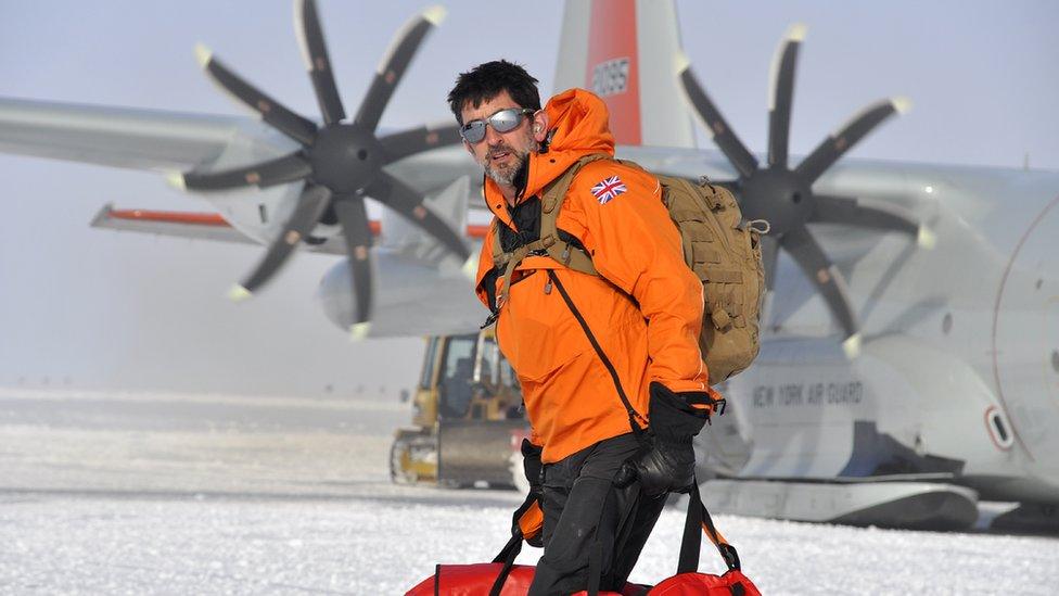 Justin Rowlatt in the Antarctic snow with bags