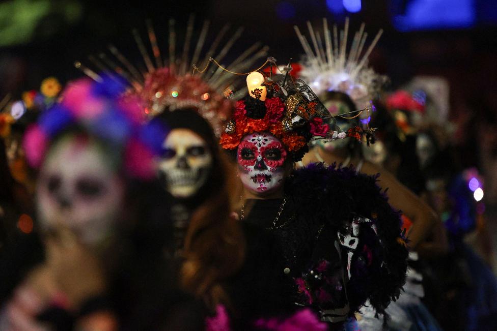 Participants dressed as the popular Mexican figure Catrina perform during a parade, as part of the Day of the Dead celebrations, in Mexico City, Mexico 22 October, 2023.