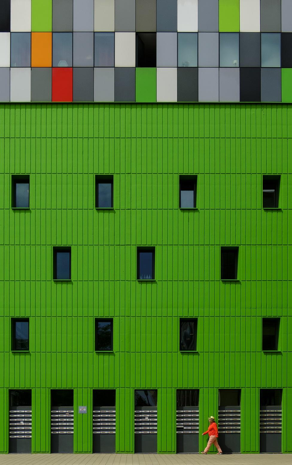 A building with a green exterior wall