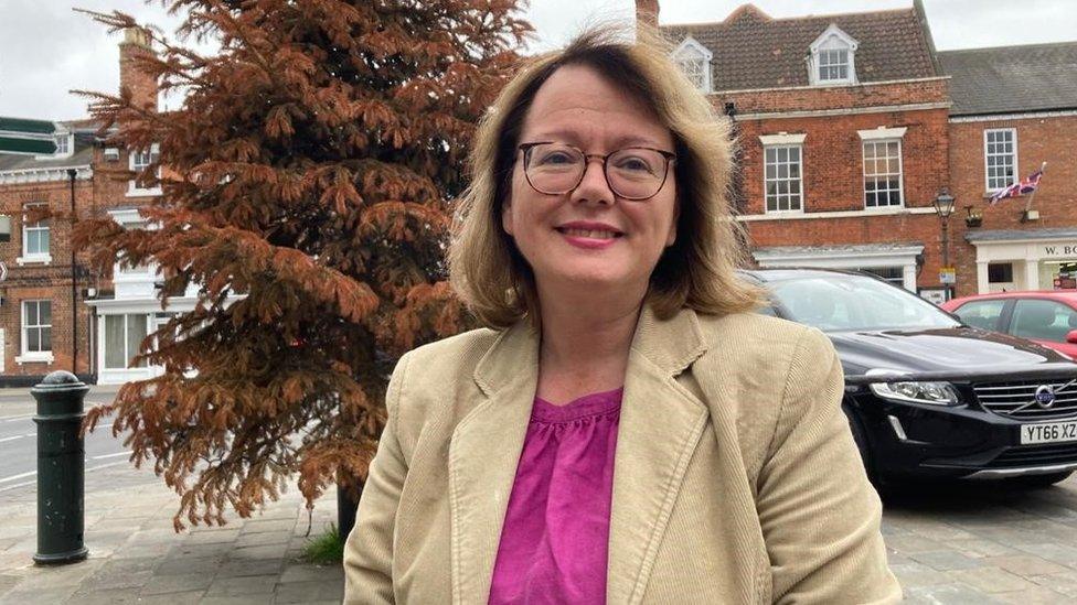 Councillor Alison Healy in front of old Christmas tree