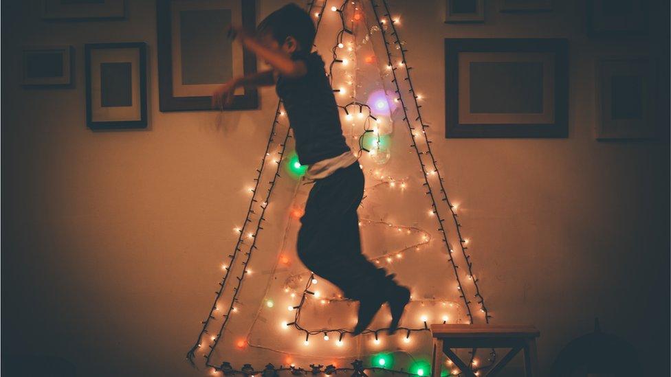 Child jumps on a chair