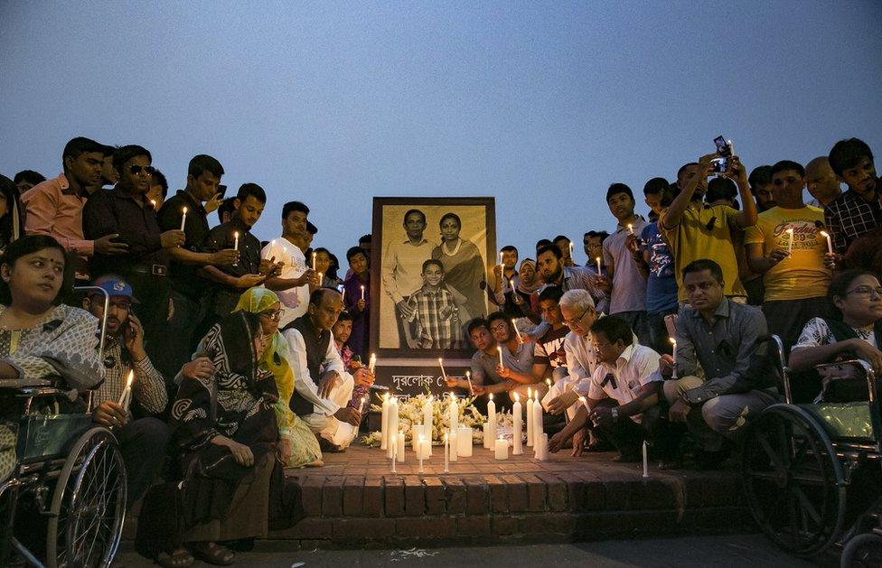 People attend a candlelight vigil for the victims of the US-Bangla plane crash.