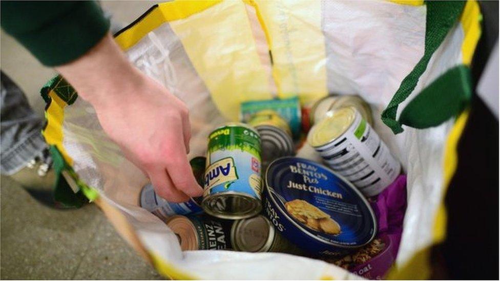 A volunteer packs food at a food bank