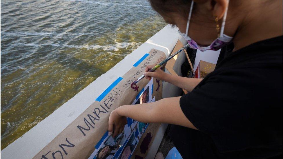 Some protesters dropped flowers into the water from the bridge