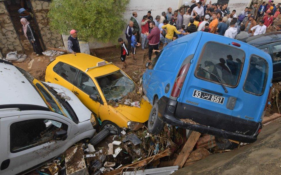 Cars are piled up in a street after being swept away by torrential rains in the city of Mohamedia near the Tunisian capital Tunis on October 18, 2018