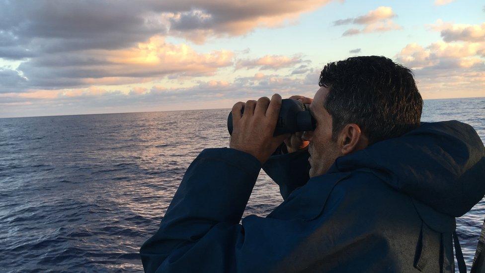 Tripoli Coastguard skipper Mohammed Garbaj scanning the horizon for smugglers and migrants in distress