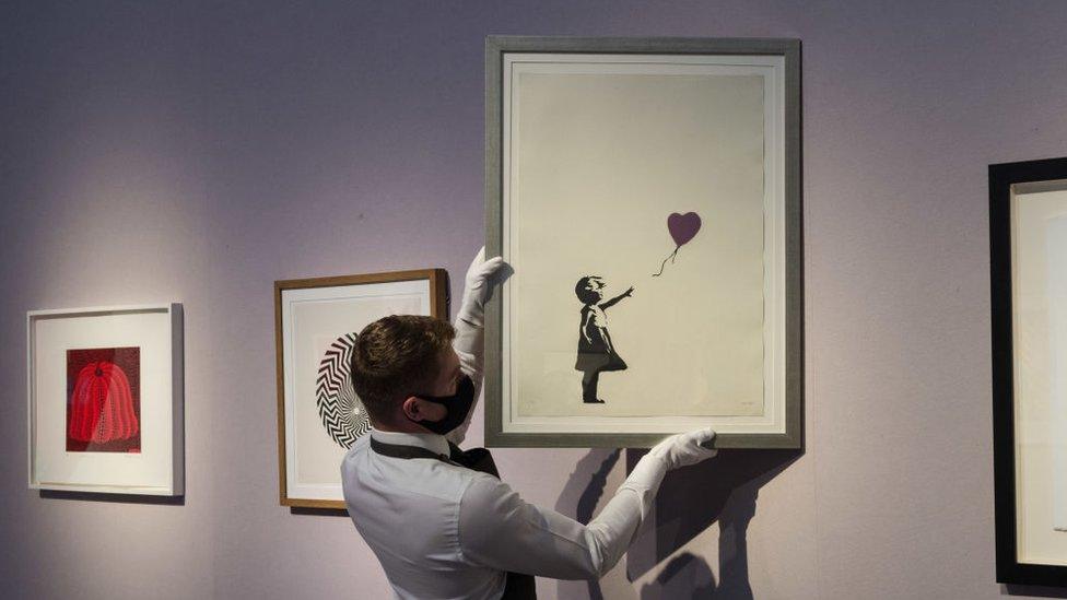 Girl With Balloon print hanging in museum