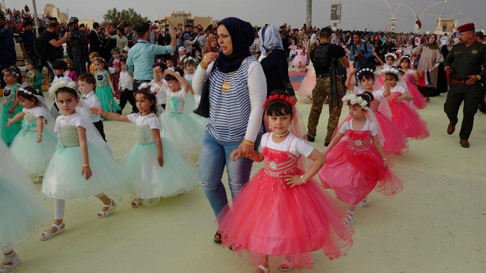 Girls in dresses at the Mosul spring festival