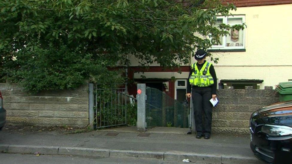 Police officer outside property