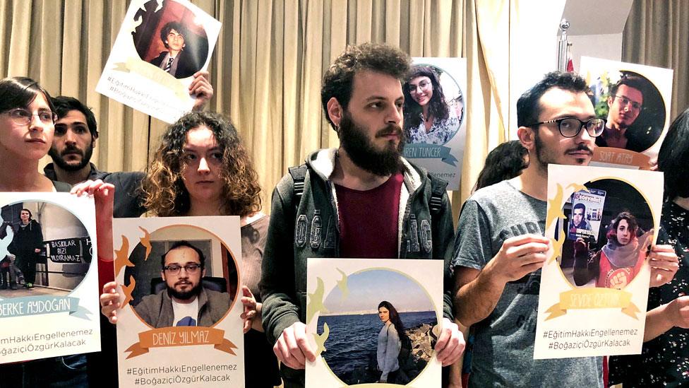 Students show posters of detained colleagues