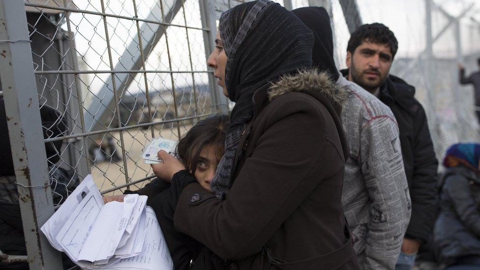 Families wait to cross the Greek-Macedonia border