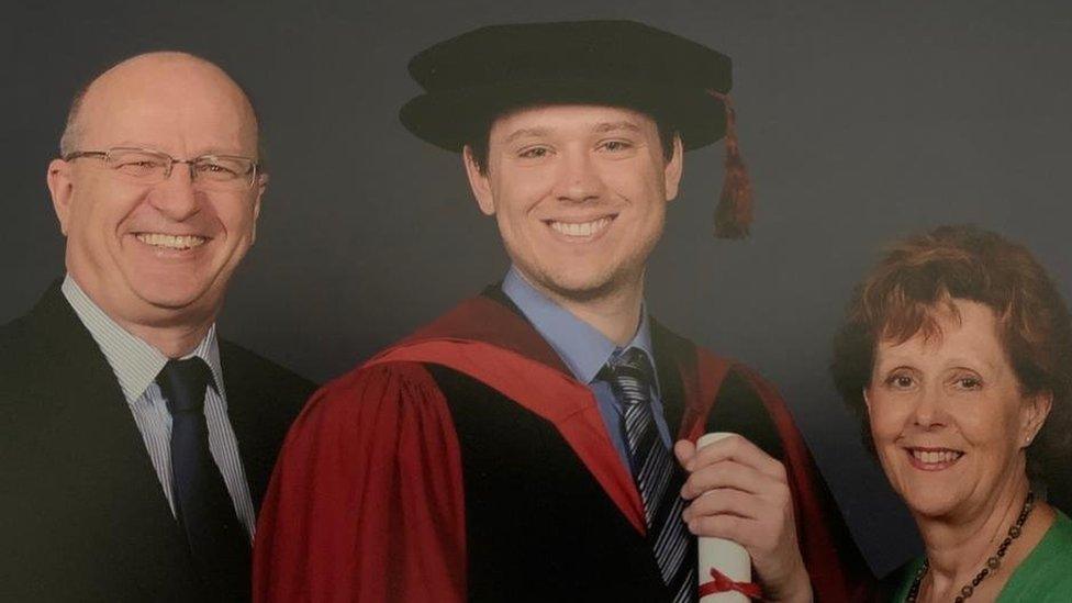 Robert and Linda Wade with their son Richard in his graduation gown and hat