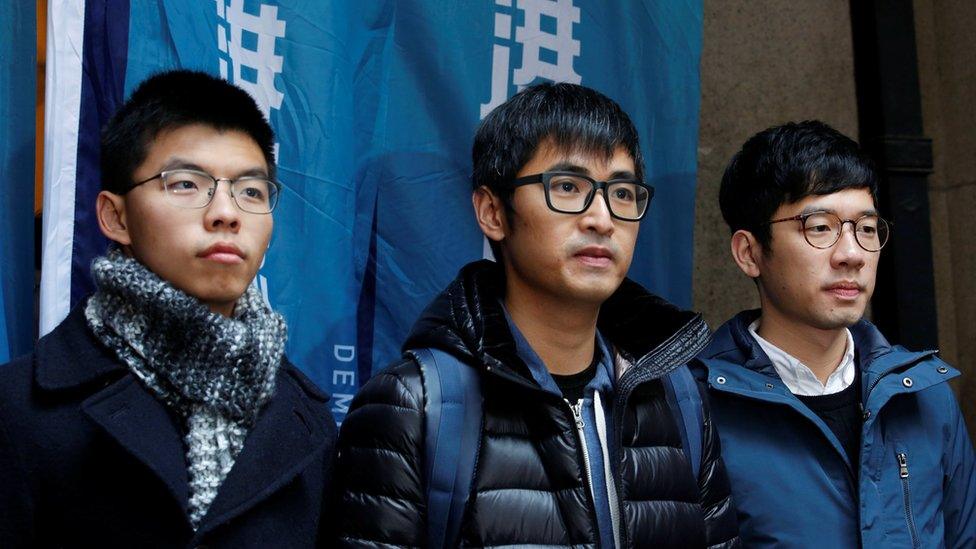 Pro-democracy activists (L-R) Joshua Wong, Alex Chow and Nathan Law outside the Court of Final Appeal