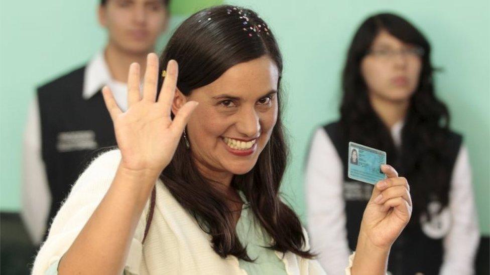 Peru's presidential candidate Veronika Mendoza of "Frente Amplio" party, shows her I.D. to the media after casting her ballot during election in the district of San Sebastian in Cuzco, April 10, 2016.