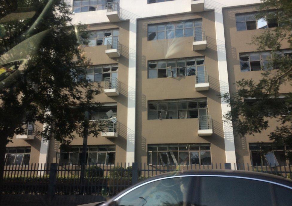 Broken windows on buildings outside Tianjin