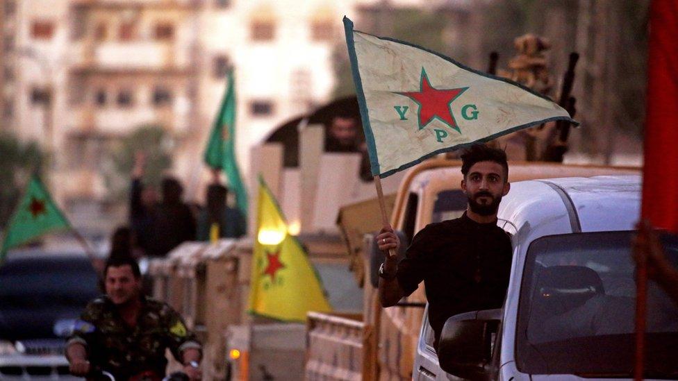 Supporters and members of the Syrian Kurdish Popular Protection Units (YPG) drive through Qamishli after the announcement of the capture of the city of Raqqa (17 October 2017)