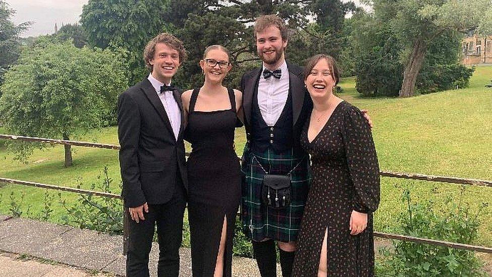 The four students in formal evening dress