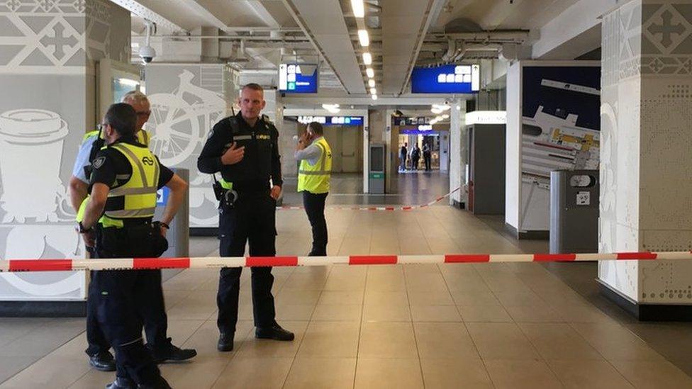 Security officials cordon off an area inside The Central Railway Station in Amsterdam on August 31, 2018