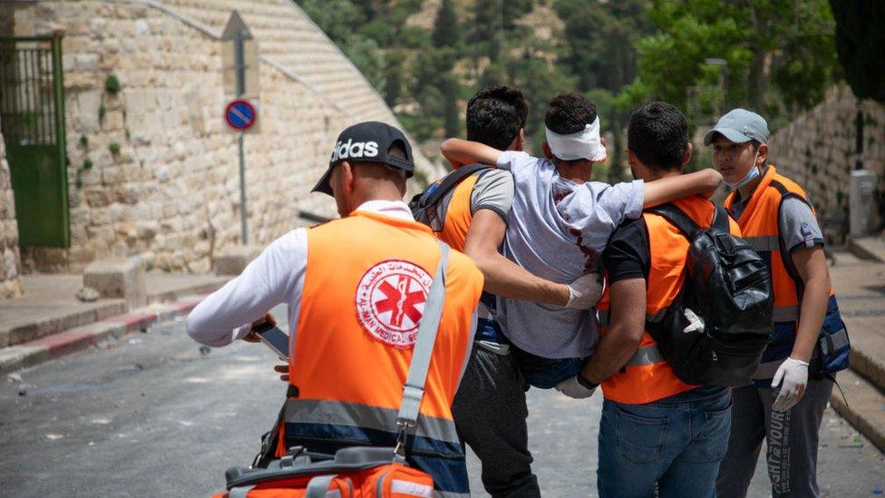 emergency services help an injured protester