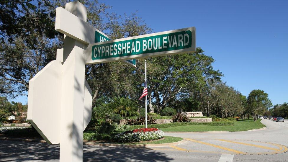 The Stars and Stripes at half-mast outside a gated community in Parkland