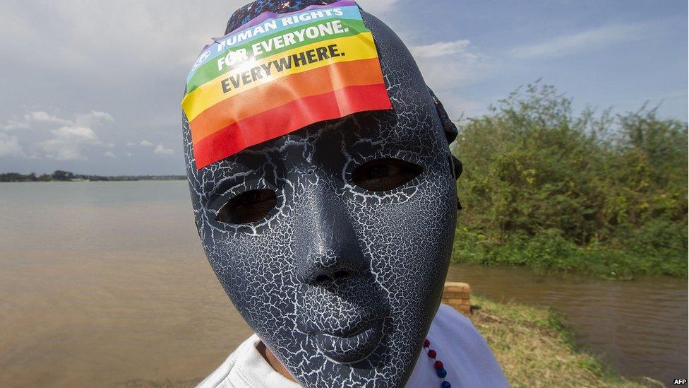 A Ugandan wears a mask with a sticker on at a gay pride rally