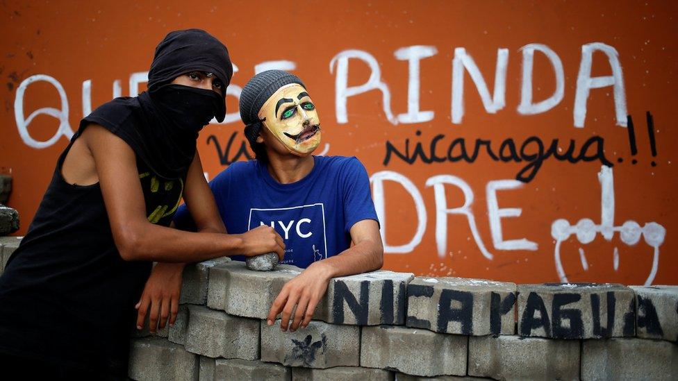 Demonstrators stand at a barricade blocking the entrance of the National Agrarian University (UNA) during a protest against President Daniel Ortega's government