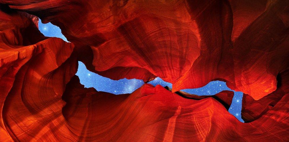 A view of the side of rock formations, looking up at the sky