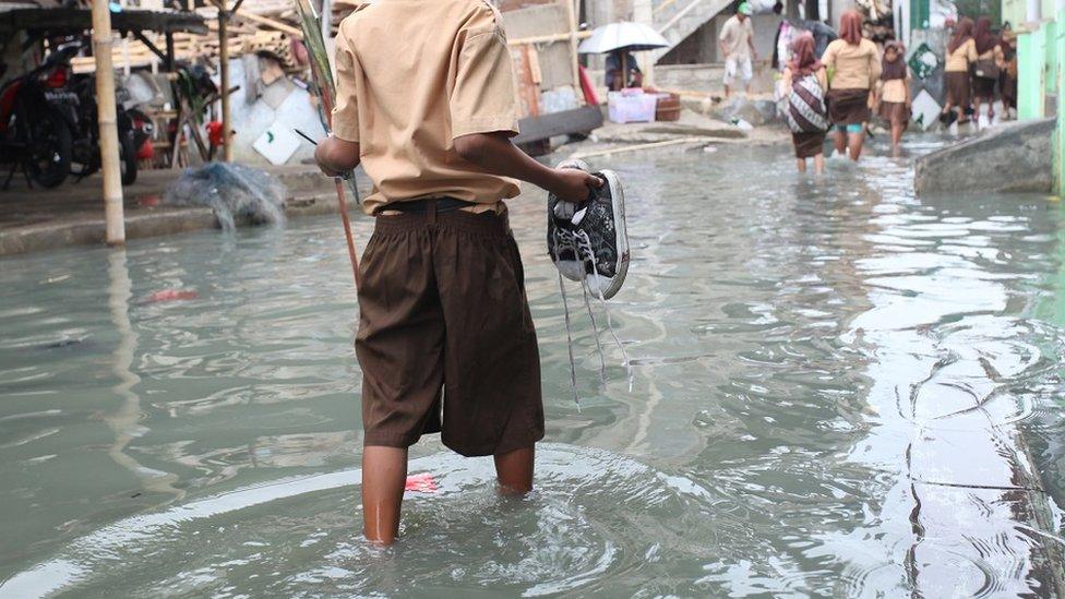 Walking in Flood Water - stock photo