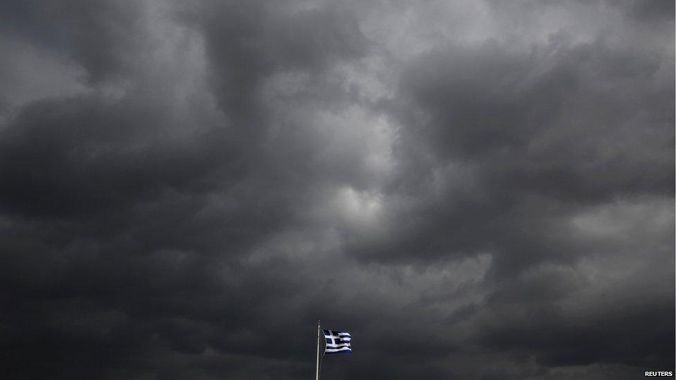 A Greek flag flutters atop the Acropolis hill in Athens