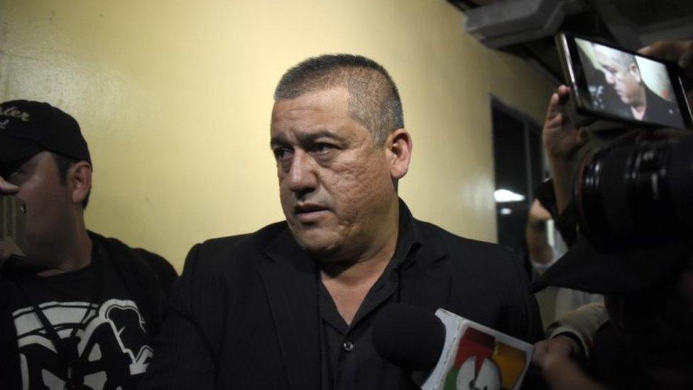 Former Social Welfare Secretary Carlos Rodas is escorted by police agents to a courtroom after being arrested in connection with the fire at a children's shelter that killed 40 girls in Guatemala City on March 13, 2017