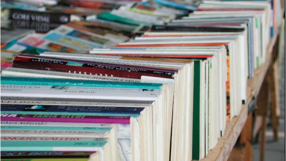 A stack of books on a table in an unidentified bookstore in London