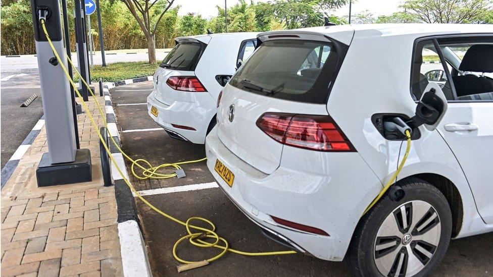 A general view of Volkswagen's Electric Golf cars at the charging station at the Kigali Convention Centre, in Kigali on November 2, 2021.