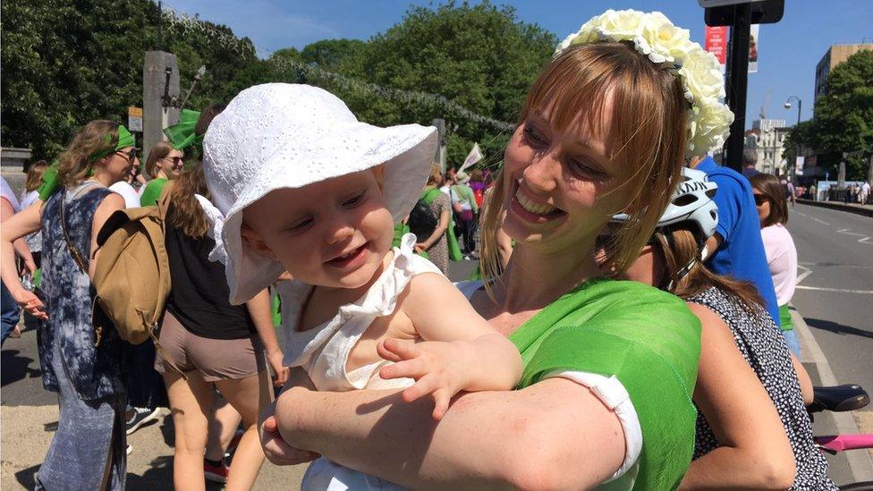 Laura Harris, 29, and Etta Kersley, 11 months, joined in the joyful celebration through the city