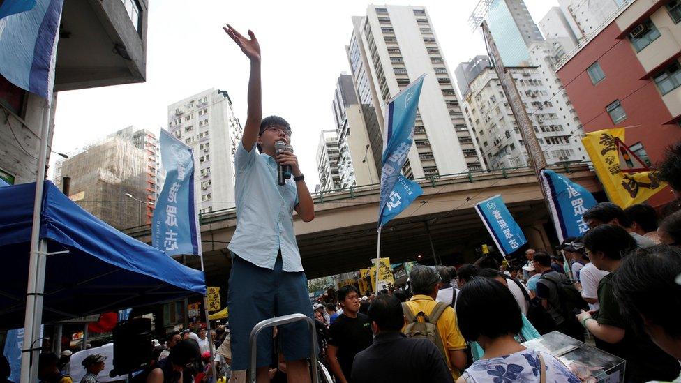 Pro-democracy activist Joshua Wong wave to supporters during a protest march in Hong Kong, China July 1, 2018, the day marking the 21st anniversary of the city's handover to Chinese sovereignty from British rule.