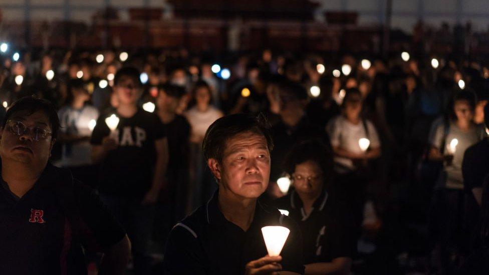 Participants take part at the candlelight vigil as they hold candles at Victoria Park on June 4, 2018 in Hong Kong