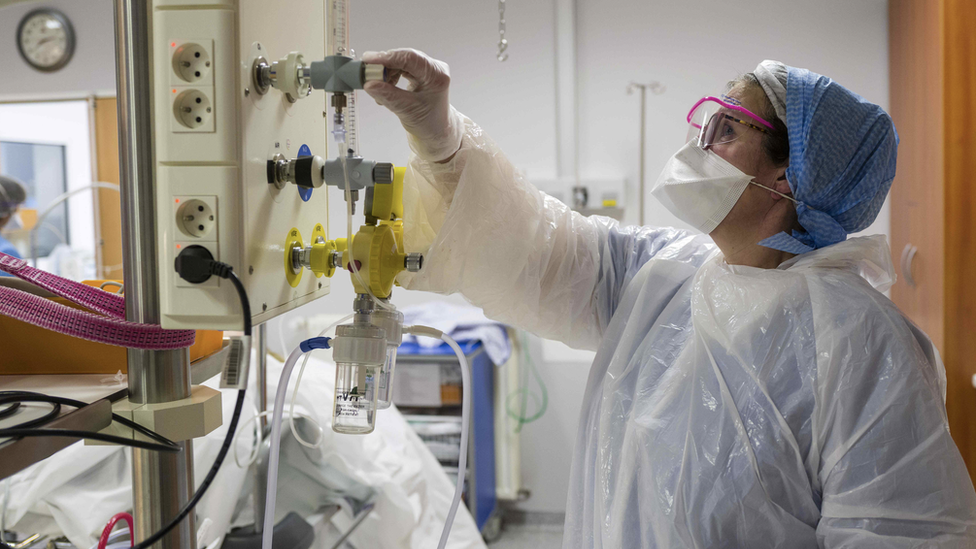 Member of medical staff adjusts oxygen supply in French hospital