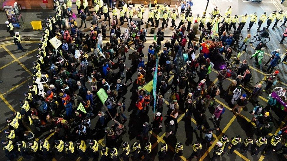 Police accompany protestors during a climate march through Glasgow