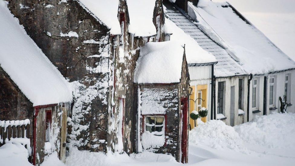 row of cottages under snow