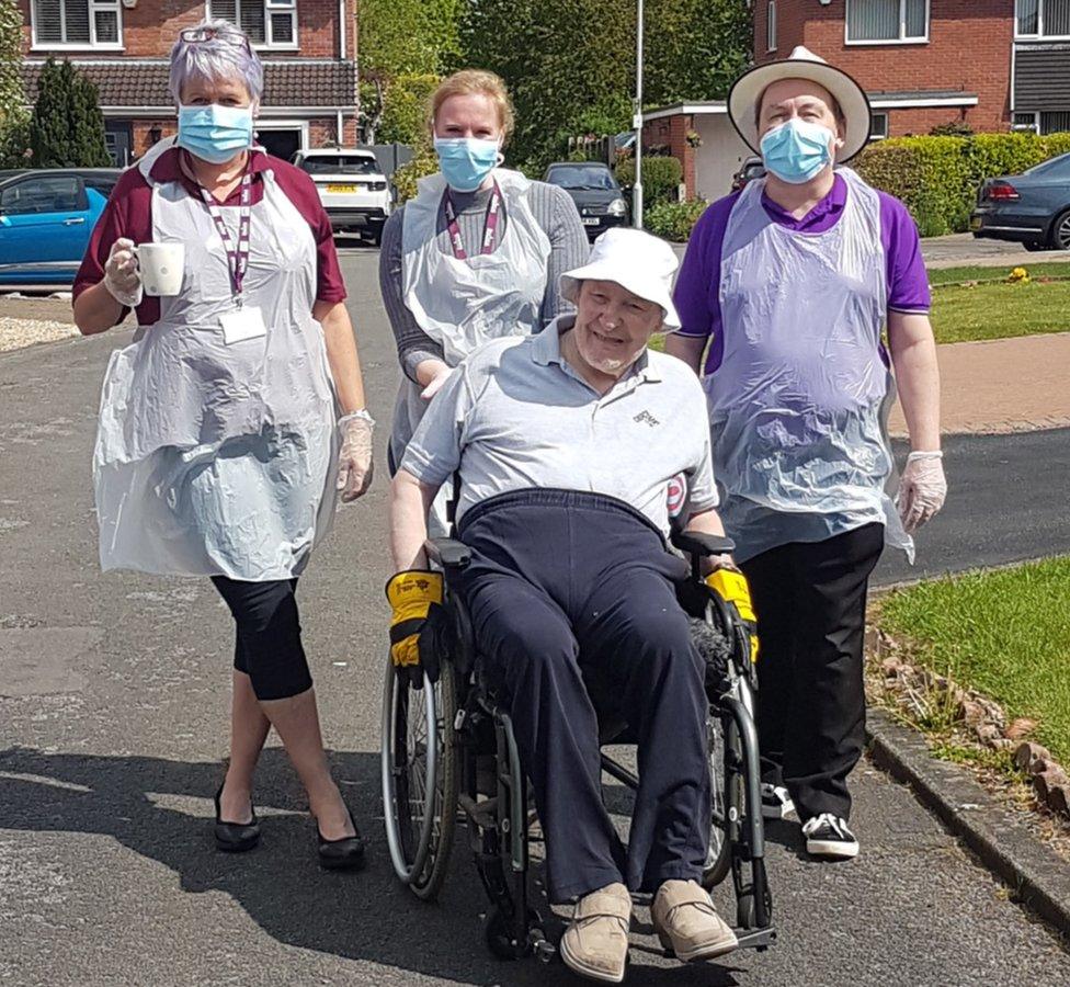 Alan Cooper with his carers who walked along side him during the challenge