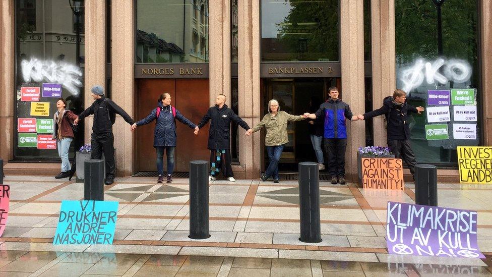 Climate protesters block the entrance to Norway's central bank