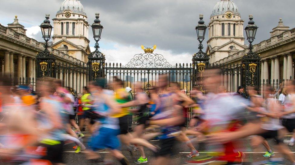 Runners pass by the Old Naval College in Greenwich