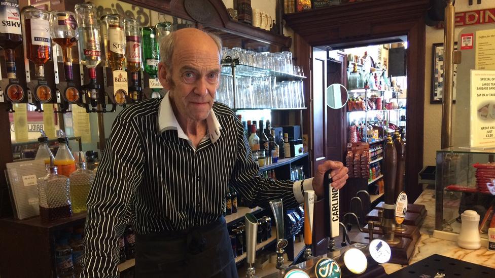 John Sadler behind the bar