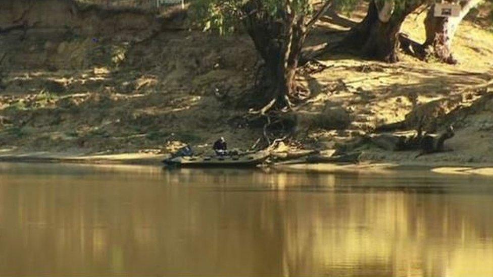 Police examine the Murray River on the Victoria-New South Wales border