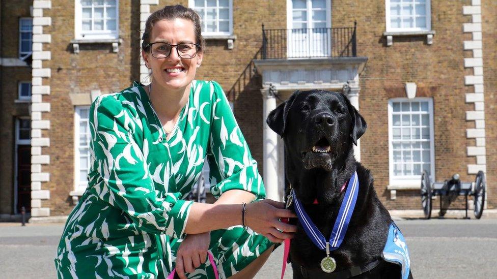 Dr Liz Spruin and Oliver the black labrador