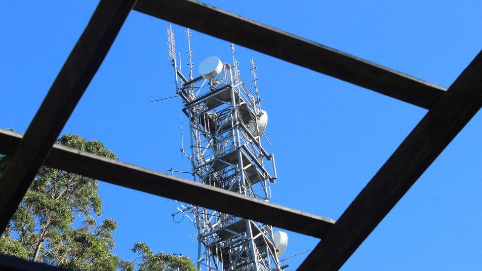 mobile phone mast seen through square windows