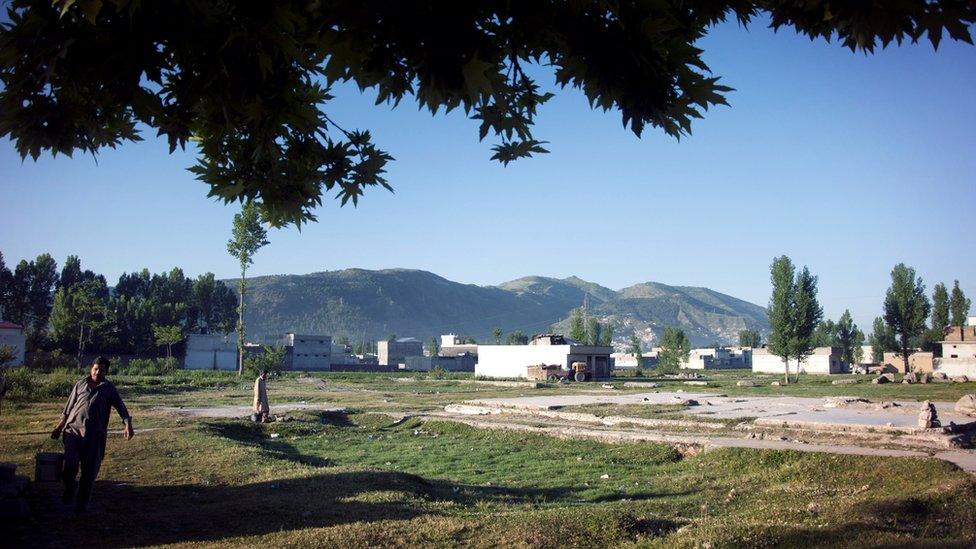 Landscape shot showing the razed compound