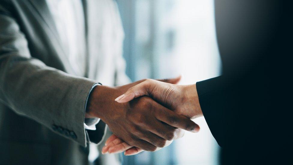 People shaking hands agreeing a deal