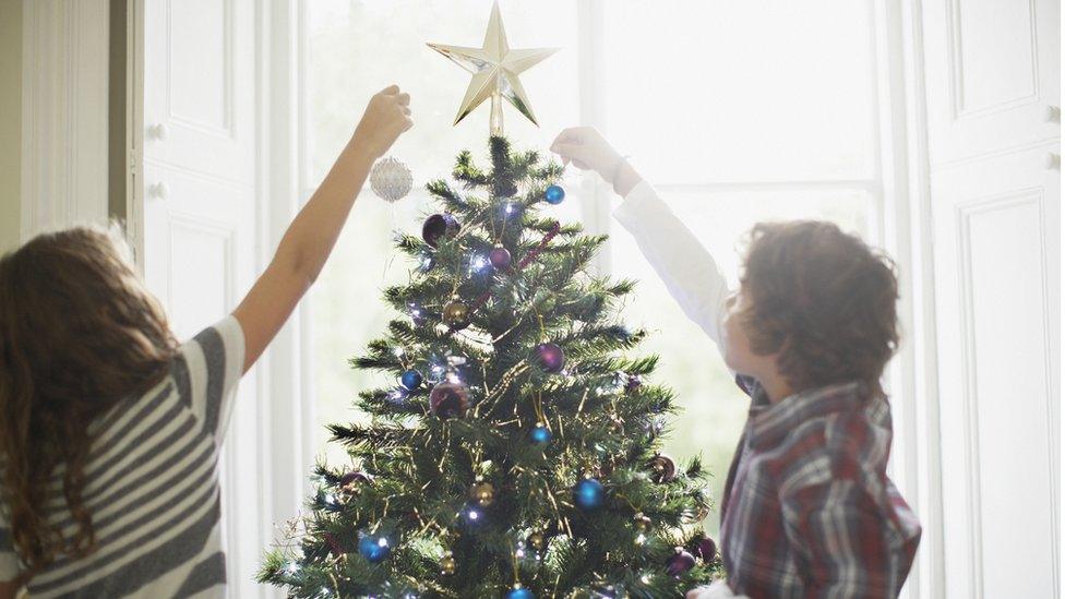 children taking off Christmas star