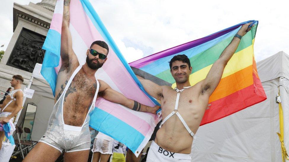 Two men holding flags