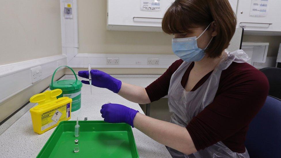 An NHS pharmacy technician at the Royal Free Hospital, London, simulates the preparation of the Pfizer vaccine to support staff training ahead of the rollout